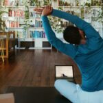 집에서도 간편하게, 건강 챙기는 ‘마이크로 운동’ 열풍 a man doing yoga in a living room